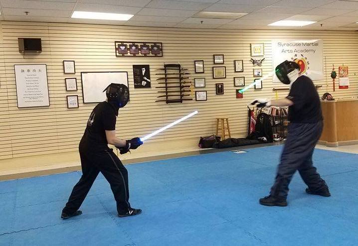 Benjamin Judkins (right) sparring with his Lightsaber Combat instructor, Anthony Iglesias at a TPLA school in New York State.